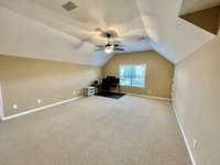 Second floor bonus room with vaulted ceilings. Great room for large gatherings! Who wants to watch football?