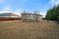 Enjoy another perspective of the spacious backyard, graced with mature trees that create a private, tranquil setting