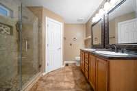 Enjoy glass-enclosed shower and durable tile flooring in the bathrooms for easy upkeep.