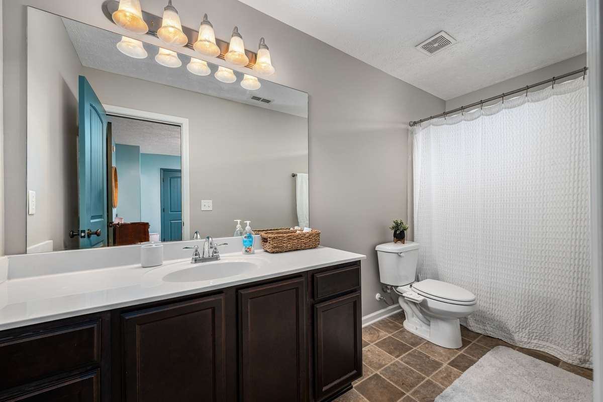 Original bathroom shot before bedroom reflected in mirror was painted cream.