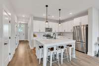 Clean, crisp and stylish! That's what you get throughout this home! Large island seats up to 6 and great for meals, games or hanging out and scrollin! Beautiful stainless steel appliance package...added bonus, the refrigerator was upgraded in 2024!