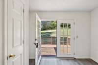 Walk out onto a large deck and patio.