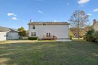 Back of home with large yard