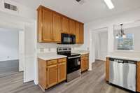 The Cabinets go all the way to the ceiling offering more storage and this kitchen has a pantry as well