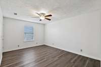 The Primary Bedroom has LVP flooring and ceiling fan
