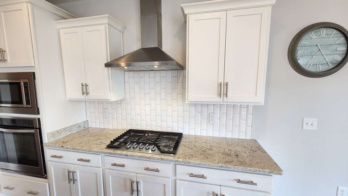Lots of cabinet storage both up and down, gas cook top, modern door hardware, granite, and stainless steel cooking appliances!