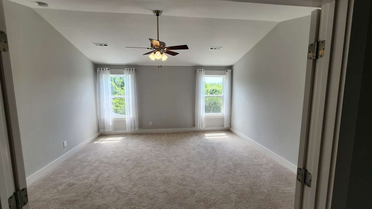 Large family bonus room on second floor with vaulted ceiling, upgraded french doors, and ceiling fan!