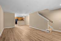 Looking toward the dinning room and open kitchen, stairs up to the bedrooms