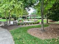 Sidewalks lead to pergola sitting area