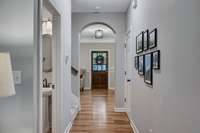 Arch Hallway with powder room and plenty of space for a gallery wall display.