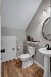 Powder Room plus extra storage below stairs, great for storing paper supplies, entertaining pieces, and holiday decor.