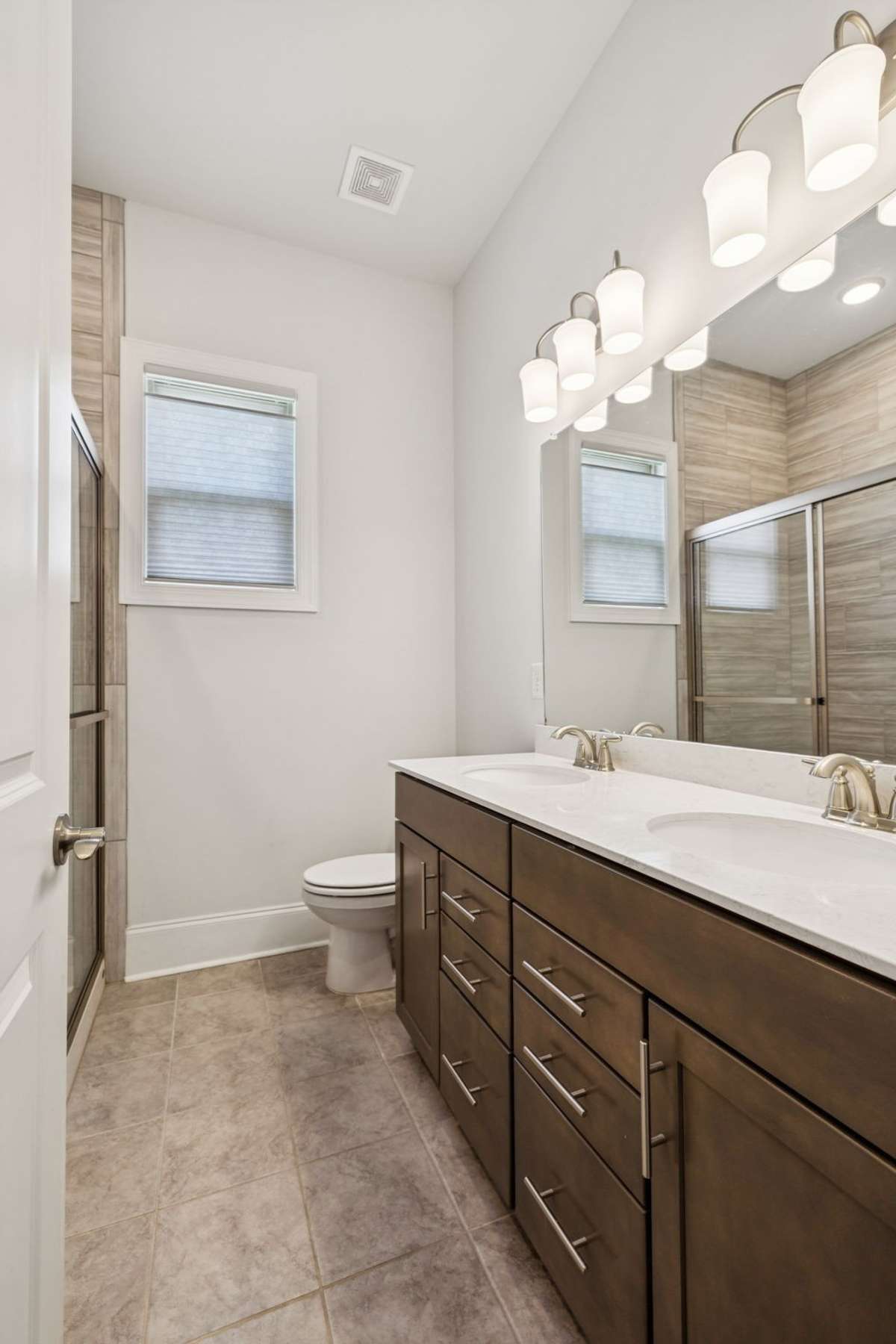 2nd full bathon main floor  with a walk in shower  his and hers sinks