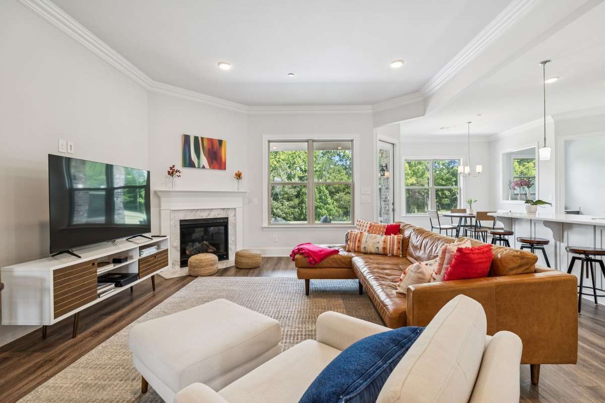 Spacious family room with a gas fireplace and lots of natural sunlight.