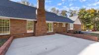 Large patio with brick wall surround.