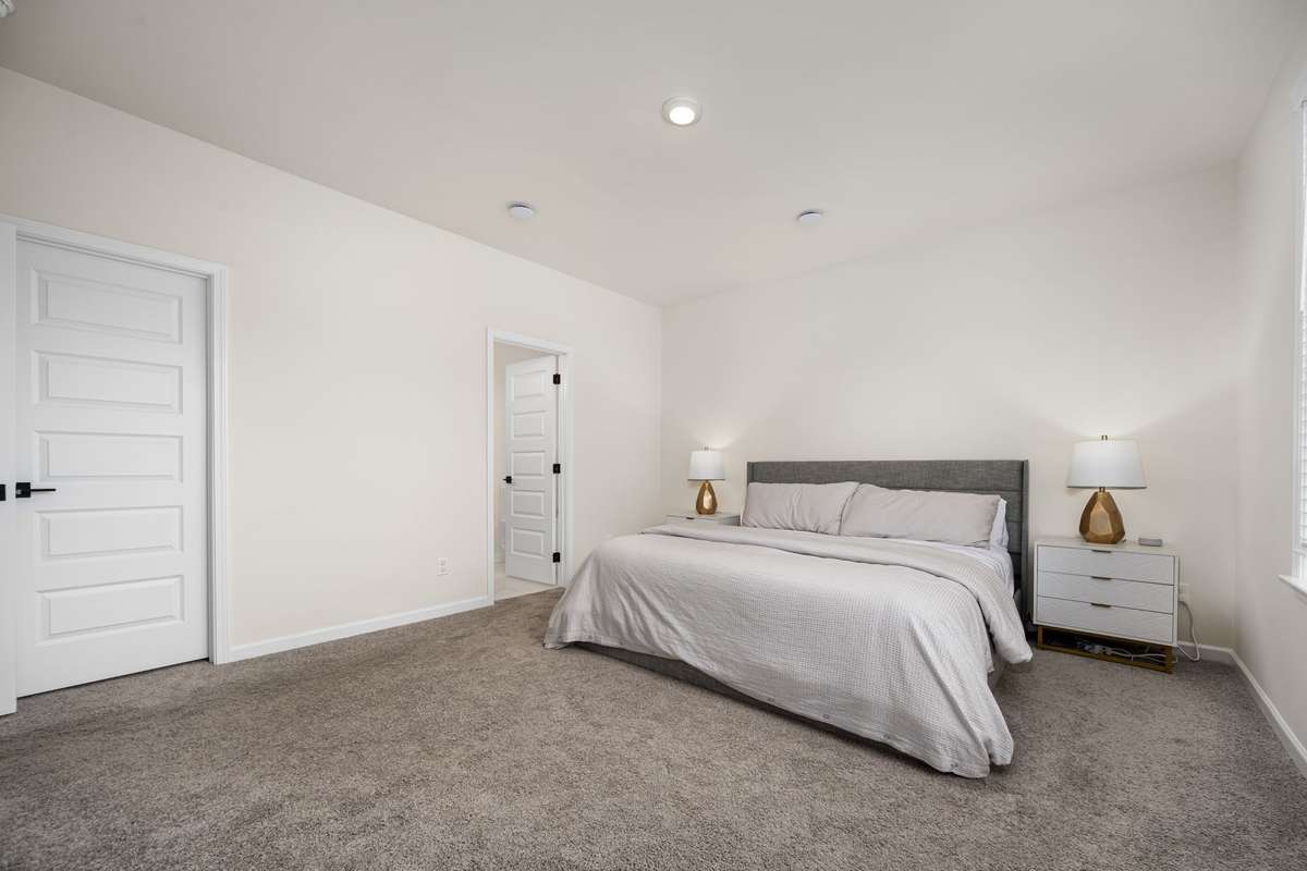 Your blank slate - Large primary bedroom on main level overlooking the backyard with two primary closets.