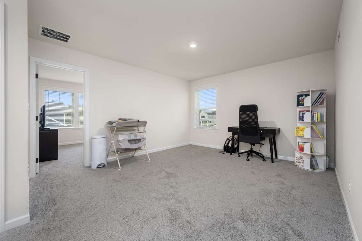 Spacious upstairs bonus area. Perfect for a playroom, office space or additional living area. There are three bedrooms on this level - perfect area for kids to have their own space.