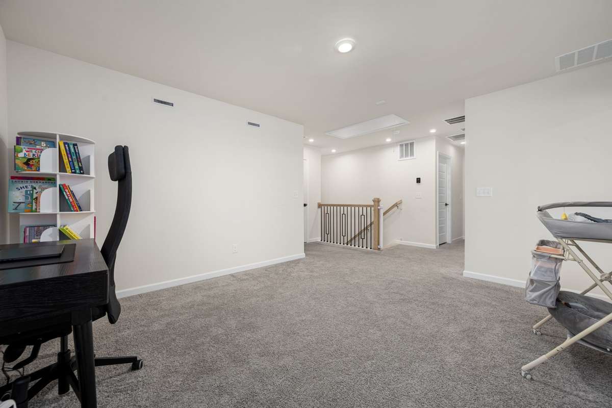 Spacious upstairs bonus area. Perfect for a playroom, office space or additional living area. There are three bedrooms on this level - perfect area for kids to have their own space.