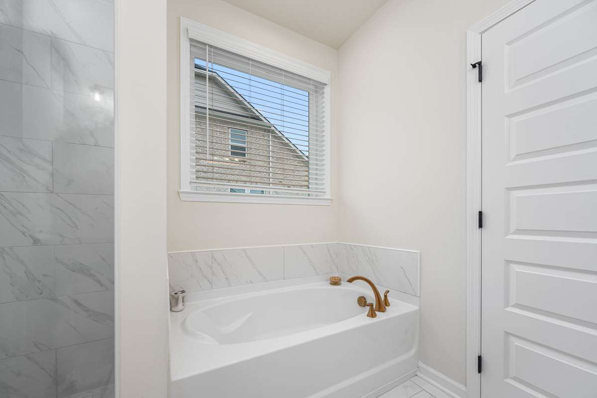 Separate soaking tub makes this primary bathroom feel like a spa