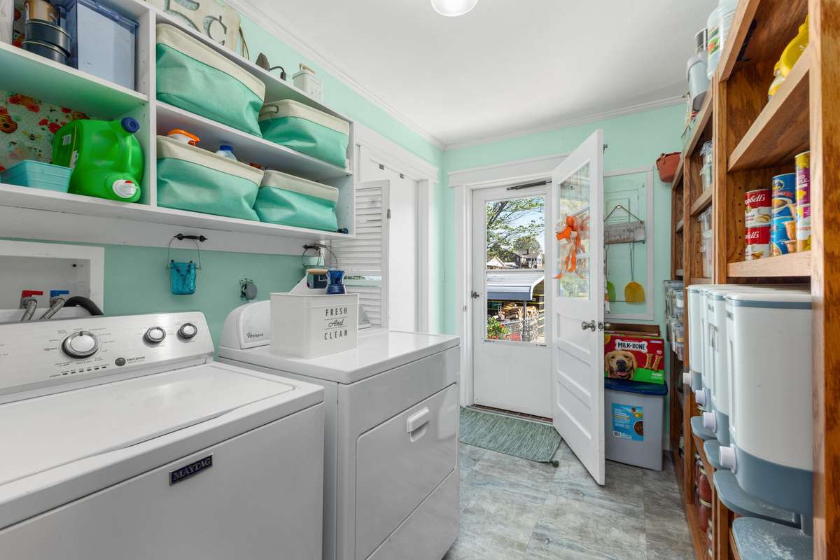 Laundry room with access to outside and to the left access to the garage.