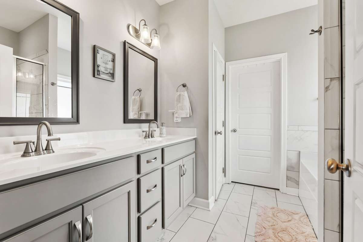 Primary bathroom provides his and her vanities, large closets, and elegant fixtures.  561 Tacoma Dr Clarksville TN 37043