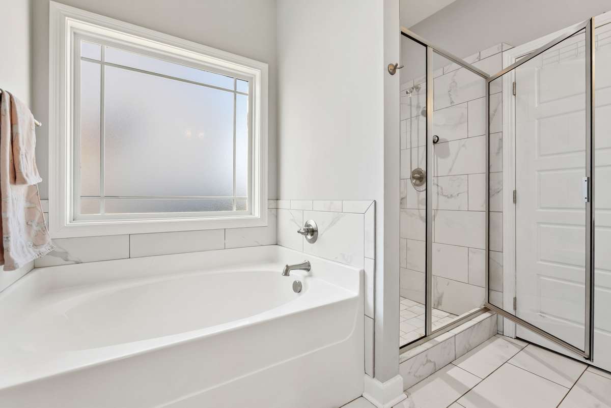Separate built-in shower and tub, with clean tile and frosted window.  561 Tacoma Dr Clarksville TN 37043