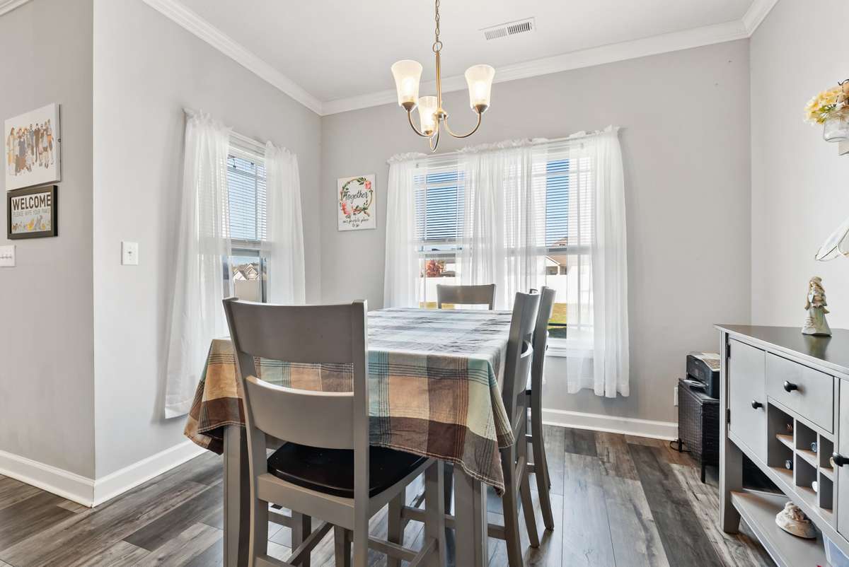 Formal dinning area showed in natural lighting with an elegant overhead light fixture.  561 Tacoma Dr Clarksville TN 37043