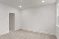 Another view of the primary bedroom, where luxury meets comfort. This generous space offers a serene retreat, complete with large windows that flood the room with natural light and provide stunning views.