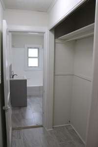 Entrance to bathroom with closet to the right.