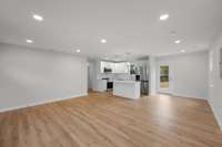 A view across the living area toward the kitchen and dining areas.