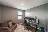 The main level guest room provides a comfortable and private space for visitors, with ample natural light and generous closet storage.