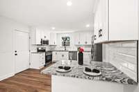 The kitchen features brand-new appliances paired with gleaming granite countertops, creating a fresh and timeless space ready for everyday living and effortless entertaining.