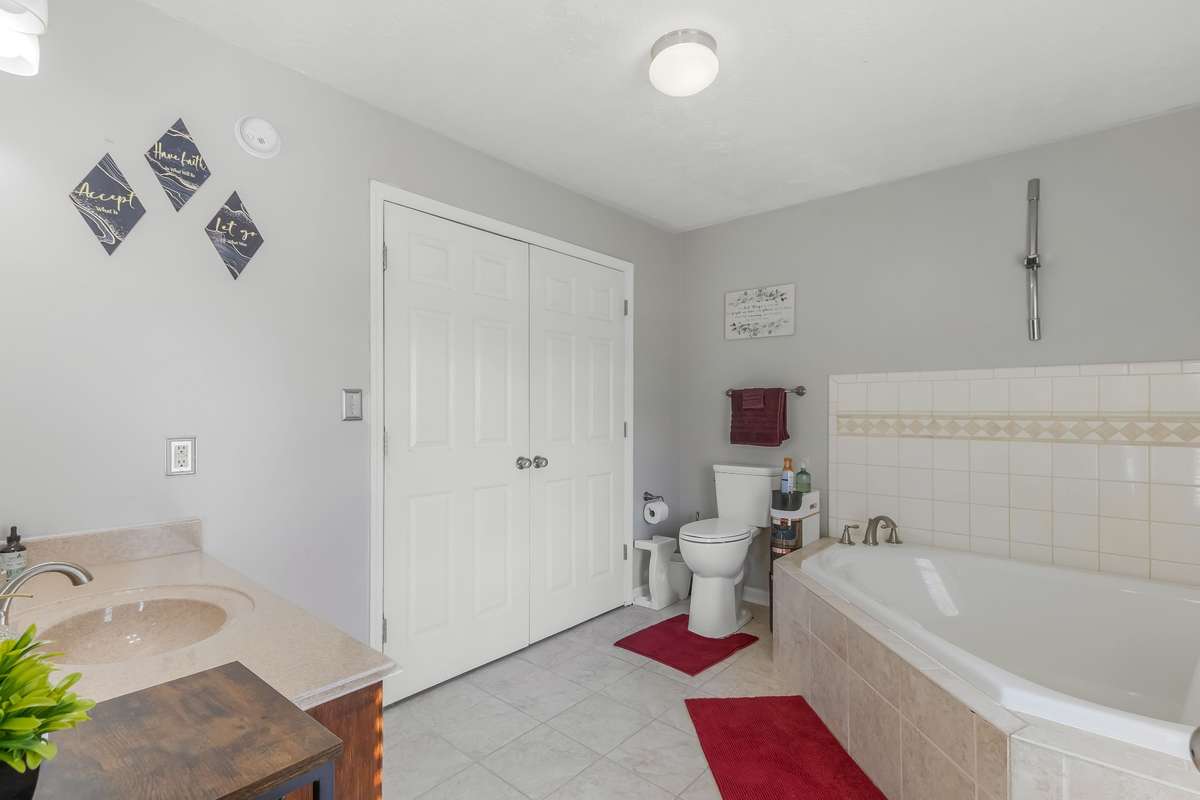 This is a spacious bathroom and behind the double closet doors you will find the laundry connections.