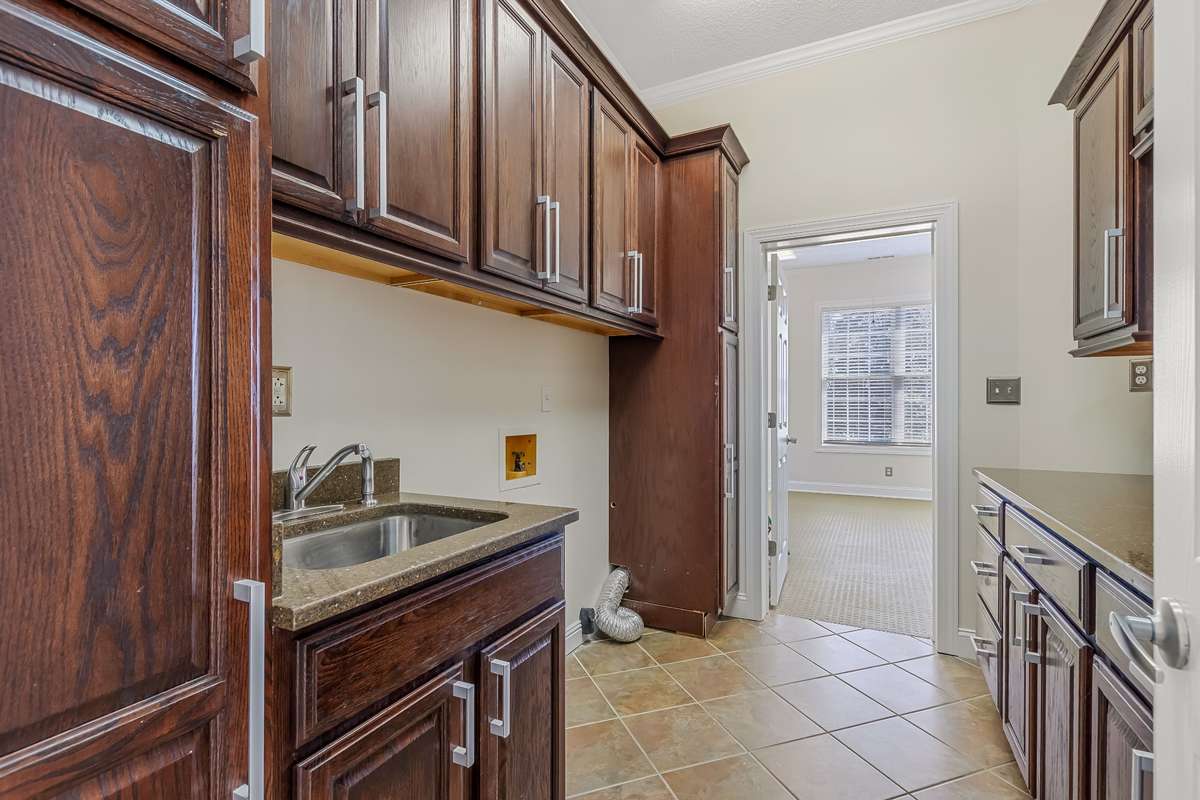 Super spacious laundry room leads you to your home gym space or use this space for all of your storage needs.