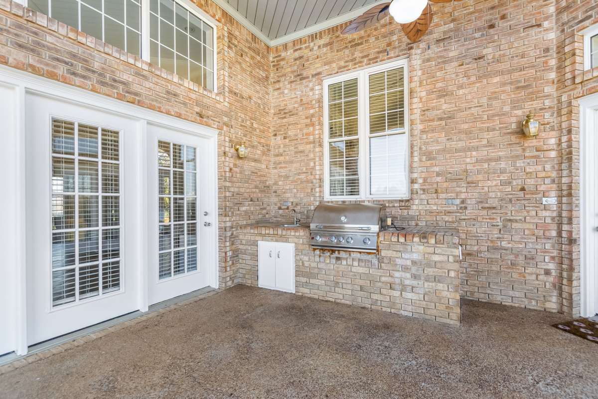 The built in outdoor kitchen is conveniently located adjacent the kitchen and offers the most incredible view of your 10.91 acres..