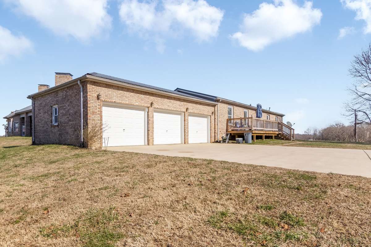 There is a three car garage located at the end of the driveway this provides storage for vehicles, tools, toys, and outdoor equipment.