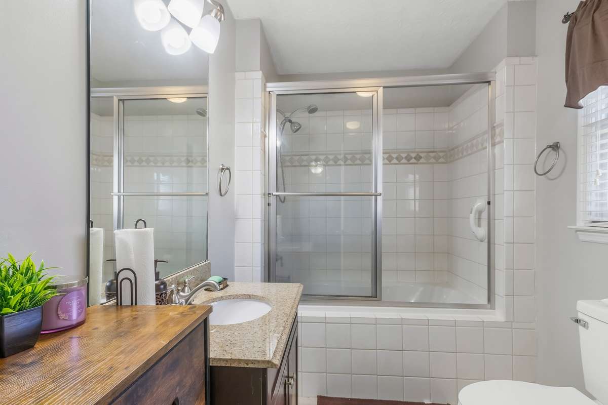 This bathroom is located inside the bedroom located on the back side of the home. The third and final bedroom inside the home was being used for storage and not photo ready.