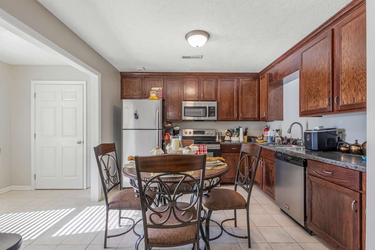 The kitchen offers plenty of space for the kitchen table or move the table to the room on the left and place an island in this space. The door ahead on the left is a small pantry. All appliances will remain.