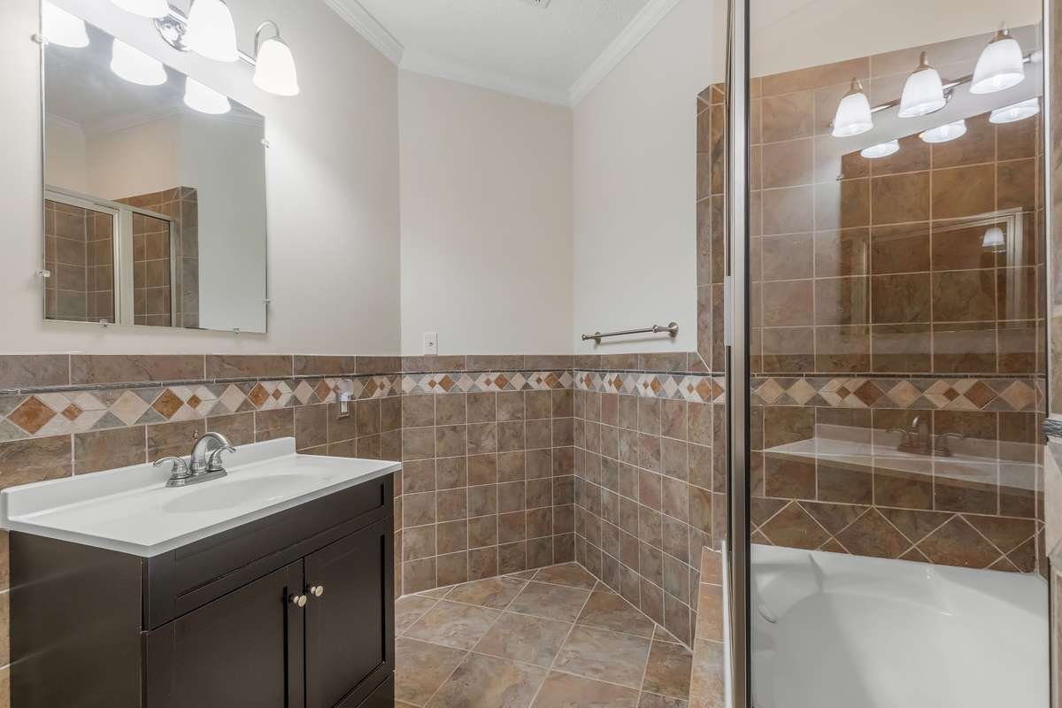 This bathroom is across from the library or home office and alongside the spacious greeting room or living room.