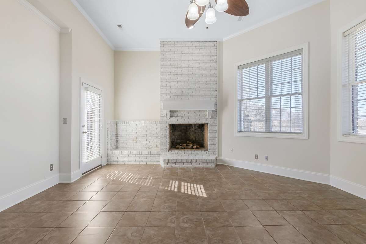 Grab your favorite book and head to the keeping room where you will find a cozy wood burning fireplace with a raised hearth and a built in brick wood box.