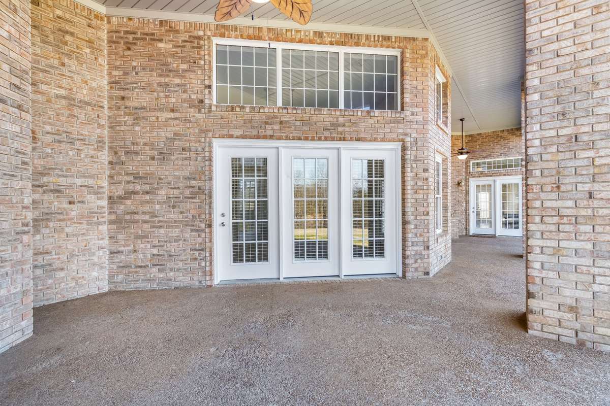 This is the second covered patio space this one is located on the other side of the home closer to the master bedroom. The land stretches far and wide ... sit down for a moment and truly enjoy LIFE!