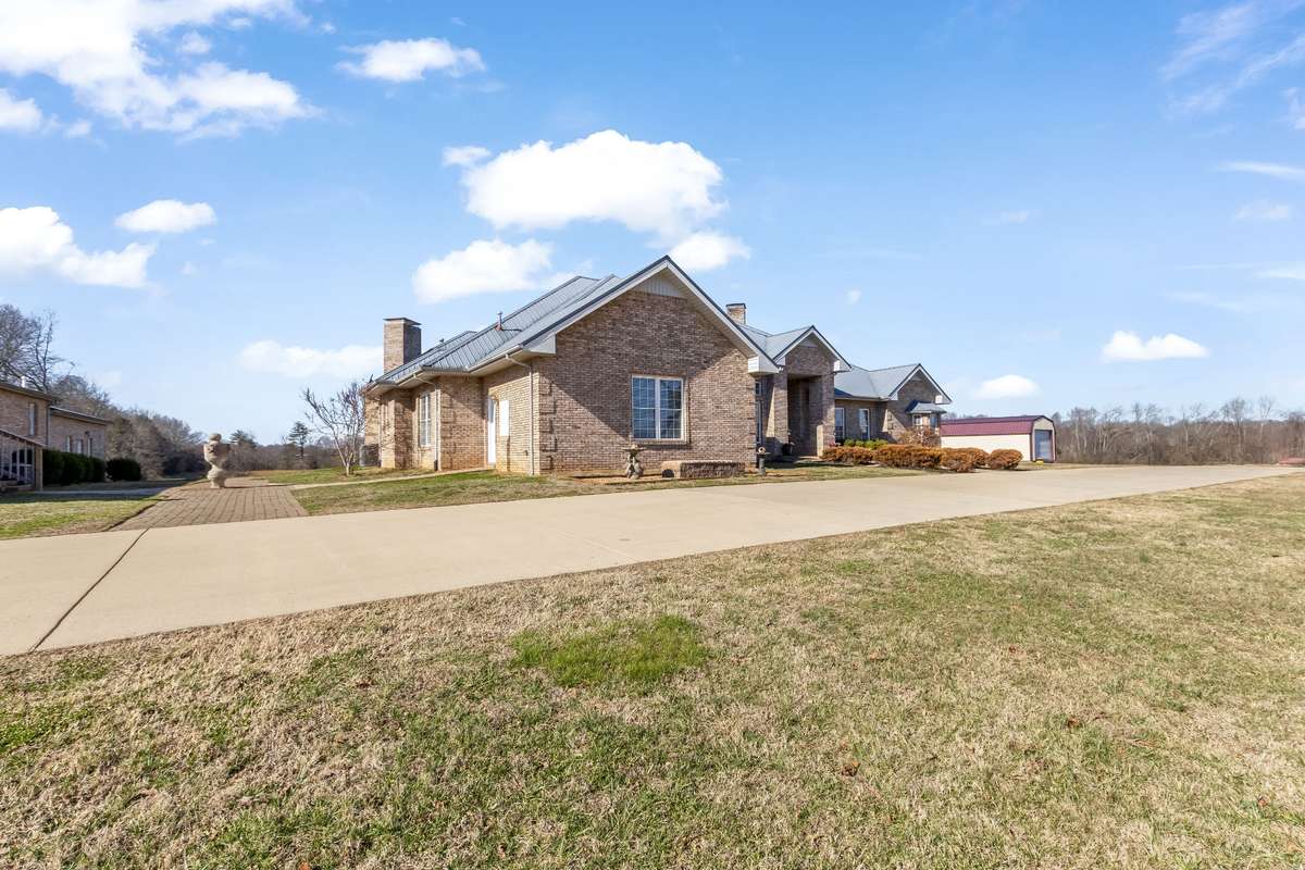 The main residence features soaring ceilings throughout the home with 4 bedrooms and 5 full baths, crafted for comfort and hosting.