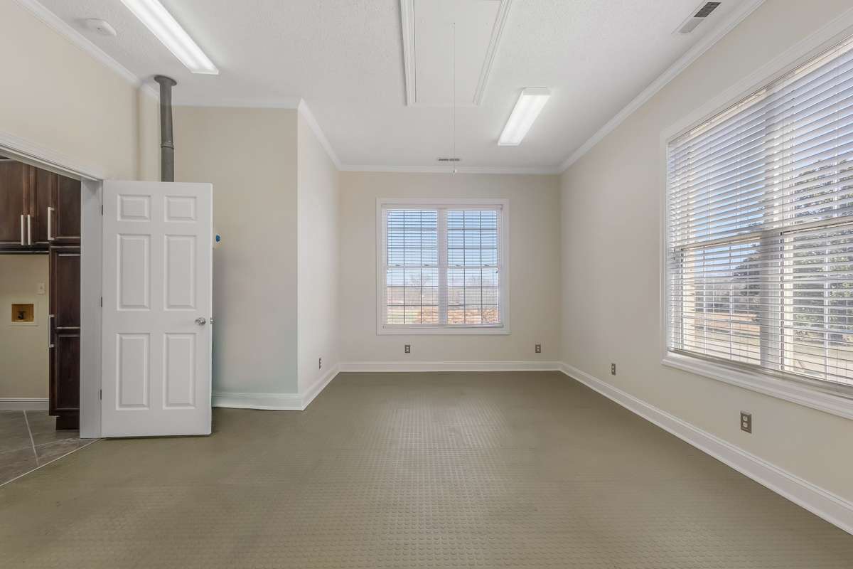 Here is another view of the home gym space. This room is located on the front of the home and overlooks the long driveway and ample parking.