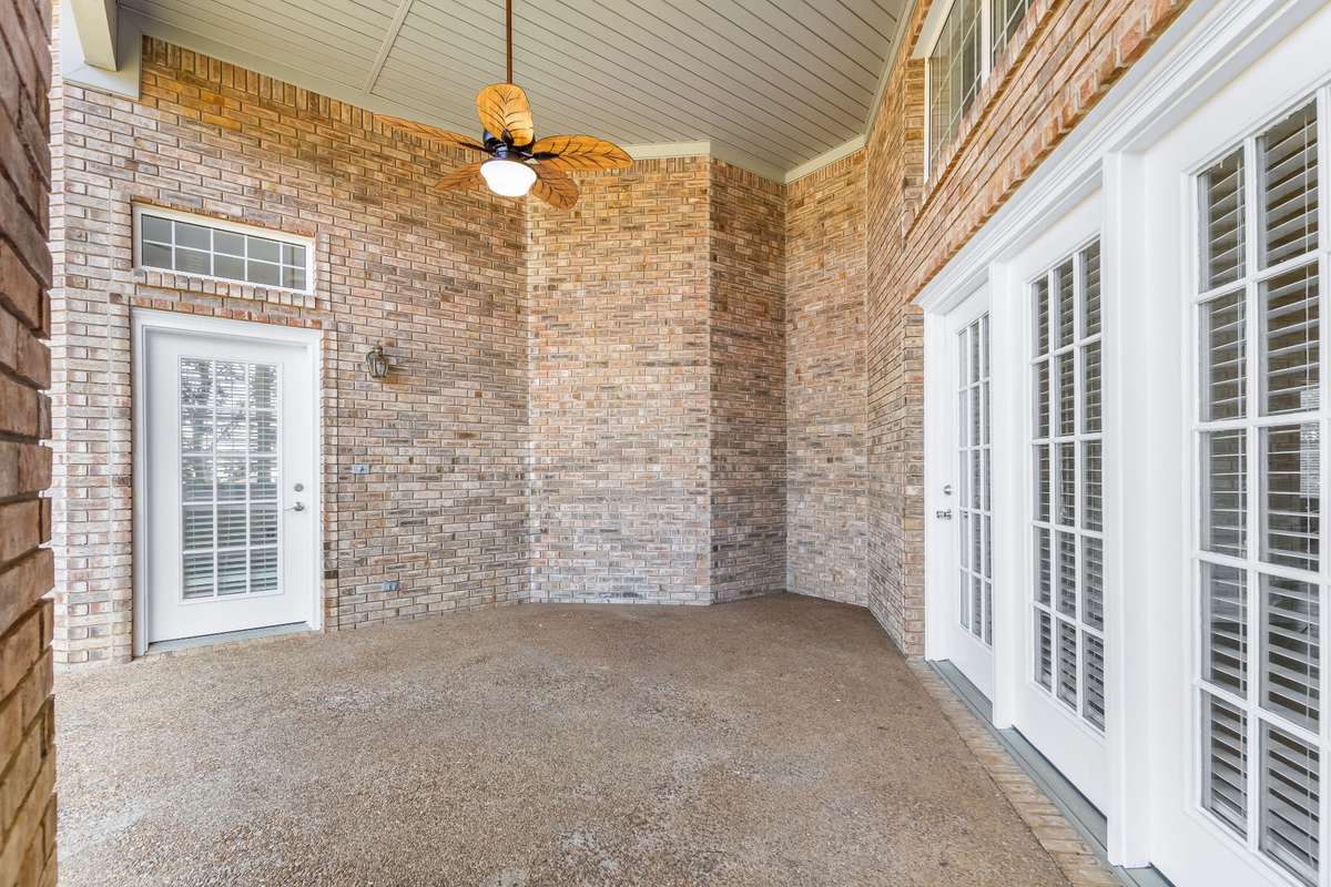 This is one of two covered rear patios... both of which offer painted sunsets and peaceful open fields. Life feels quieter ... Not a care in the world.