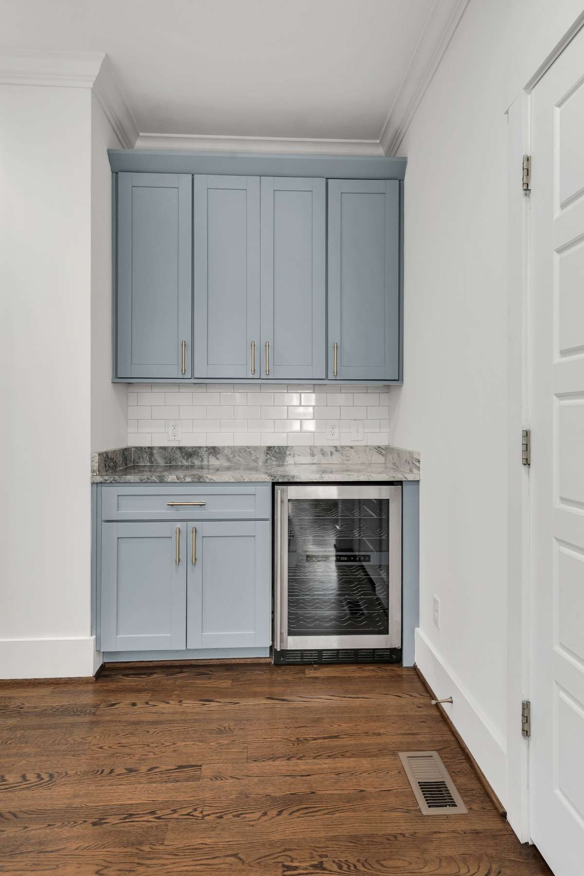 Freshly painted wet bar.  The door to the right is a 2nd Pantry or extra storage area... great for housing vacuum cleaner, mops, or extras from a Sam's/Costco run.