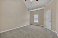 The second level features two spacious bedrooms with vaulted ceilings.