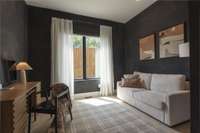 Located on the first floor, this versatile room—with its rich limewashed walls and natural light—makes the perfect guest bedroom, home office, or media space to suit your needs.