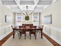 Formal dining room with intricate coffered ceilings