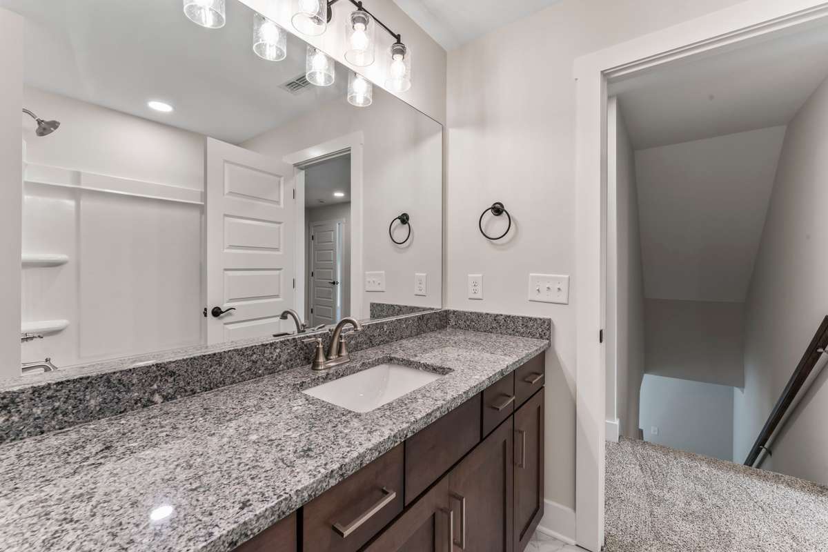 It has a large granite countertop, lots of storage and a shower-tub combo!