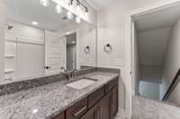 It has a large granite countertop, lots of storage and a shower-tub combo!