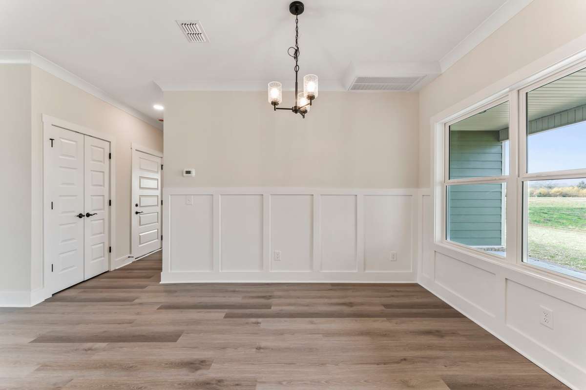 The open concept kitchen and living room aren't complete without a touch of wainscoting!